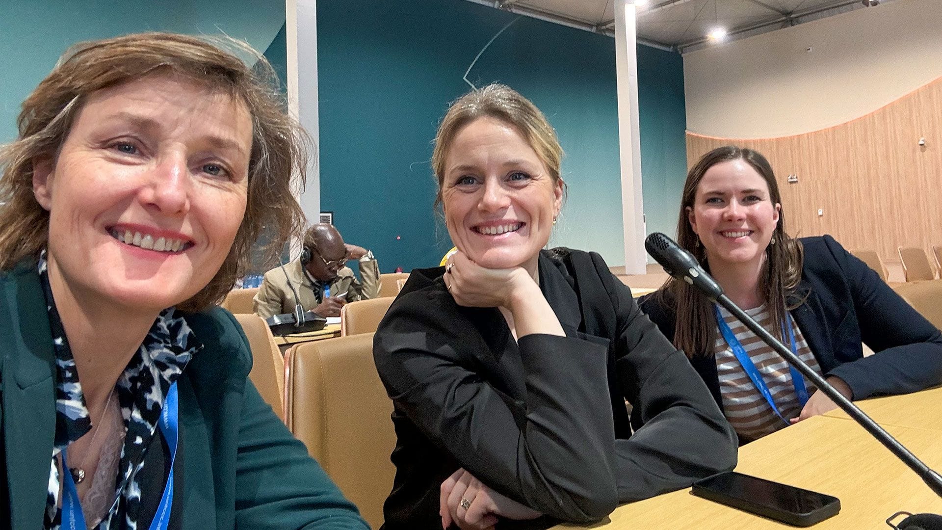 Three women at a presentation.