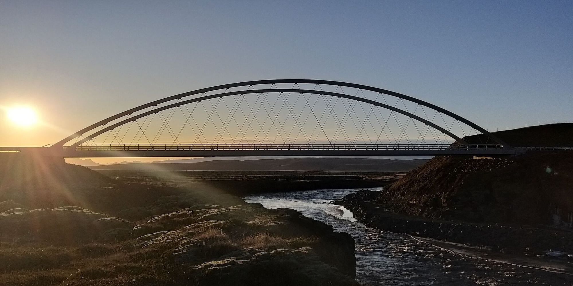 Bridge over a river at sunset.